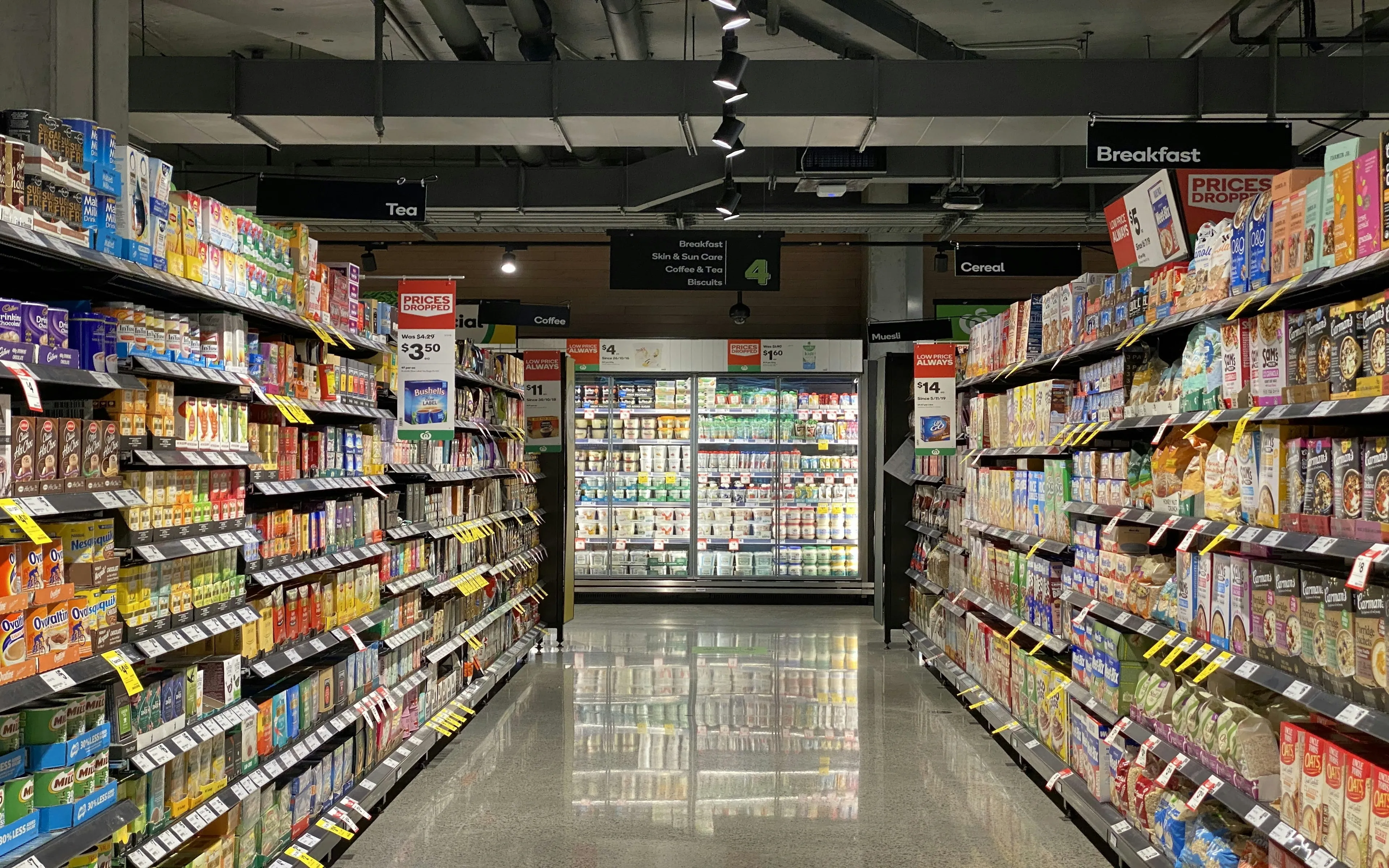 Colorful packaged grocery products lining a supermarket aisle